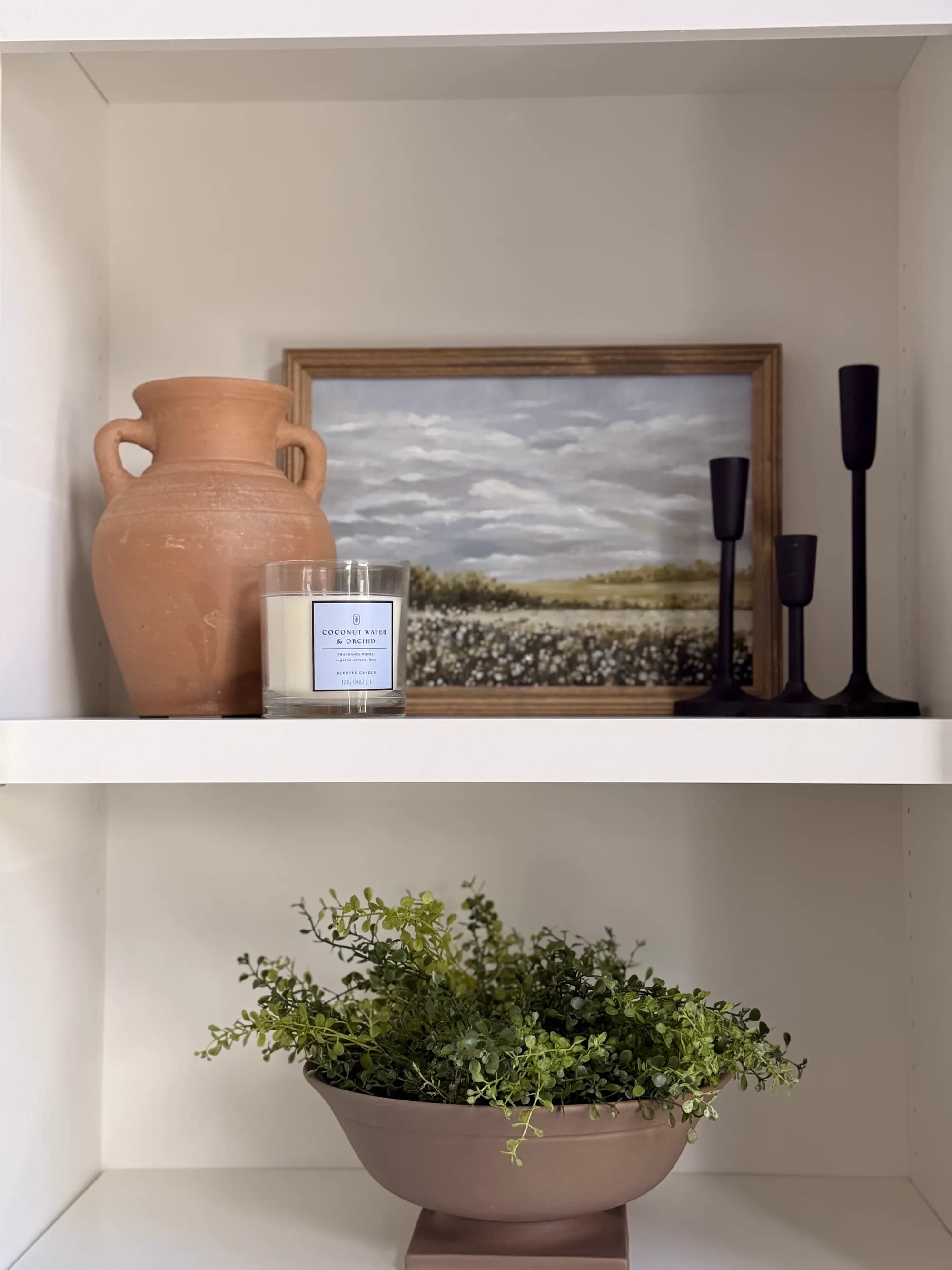 Styled shelf with terracotta vase and landscape art by BK Toolbox