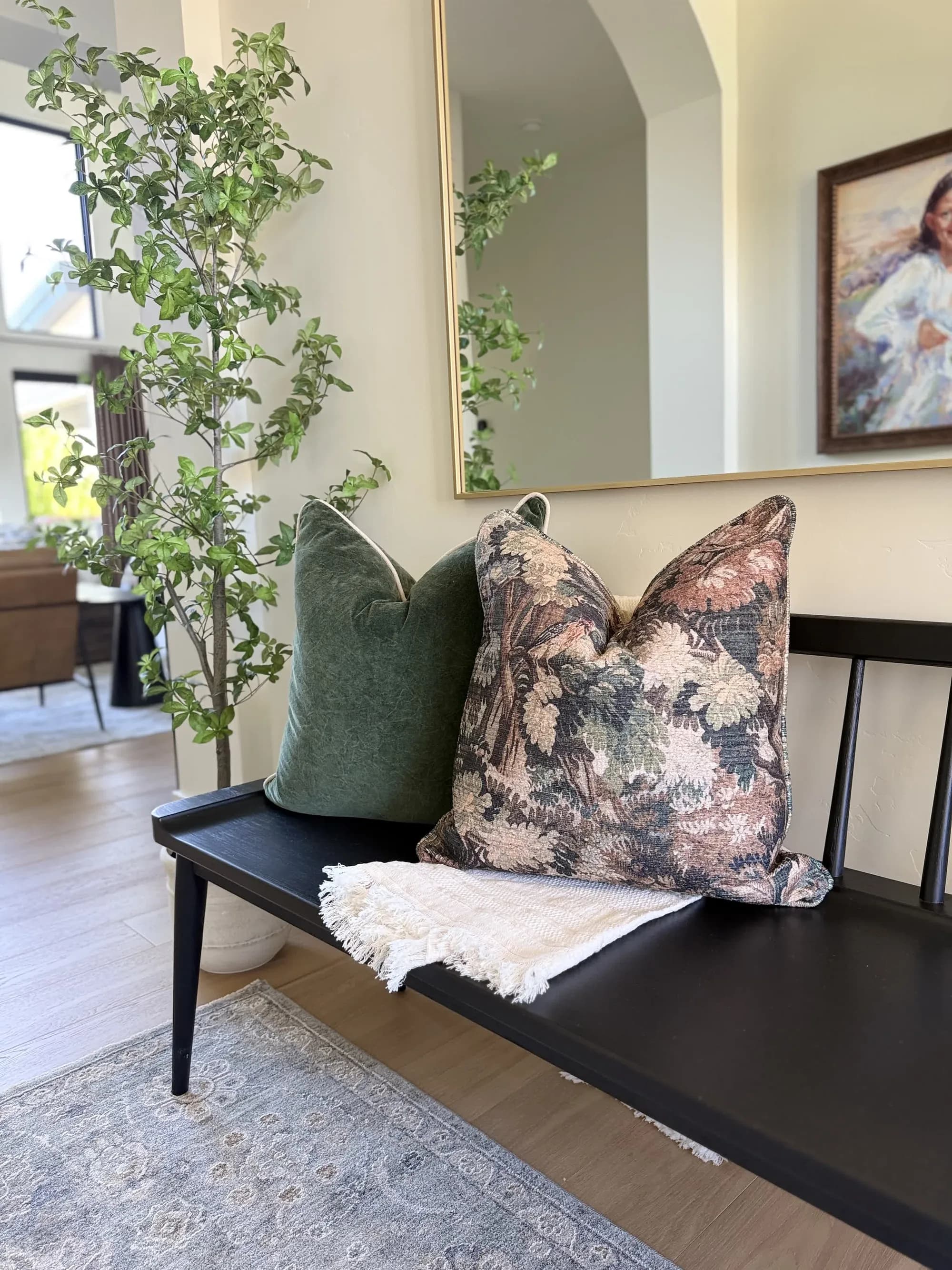 Entryway bench with layered pillows and greenery by BK Toolbox
