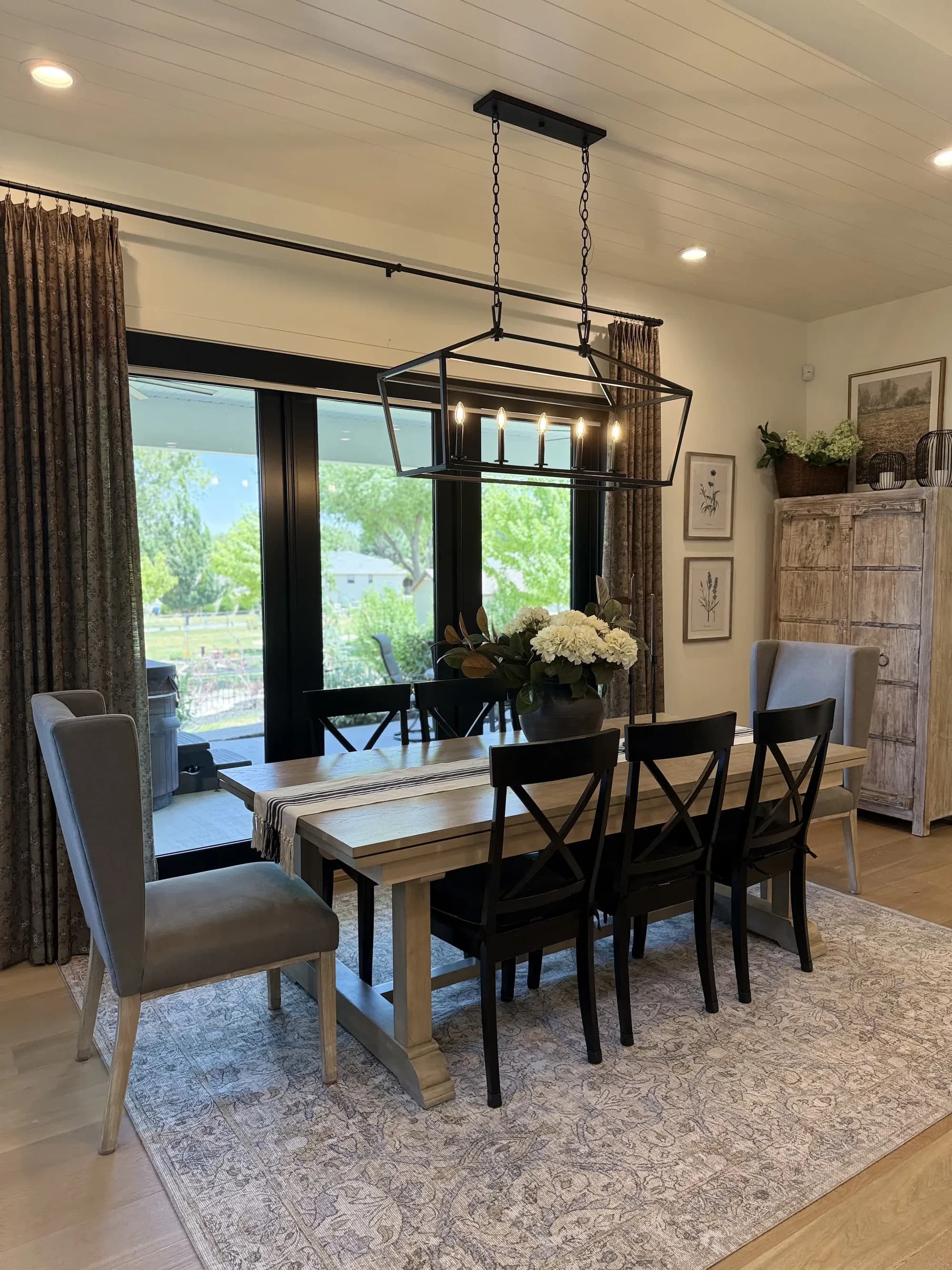 Living room with custom coffee-table styling and stone fireplace by BK Toolbox